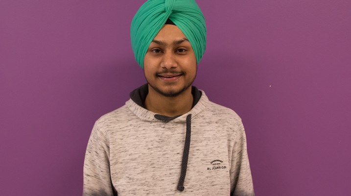 Student standing in front of a wall 